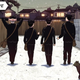 Four boys and a cat stroll down a darkened street in the cover art for Genzaburo Yoshino's How Do You Live?